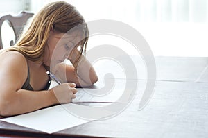 Young Girl Doing Homework at Kitchen Table