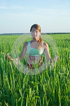 Young girl doing yoga against nature