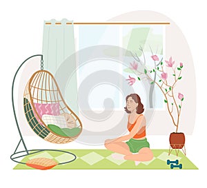 Young girl doing yoga exercises, practicing meditation and stretching on the mat. Morning routine woman in yoga at home