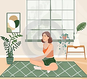 Young girl doing yoga exercises, practicing meditation and stretching on the mat. Morning routine woman in yoga at home