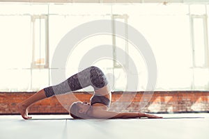 Young girl doing yoga indoors