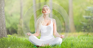 Young girl doing yoga in park