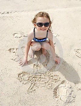 Young Girl Drawing in Sand