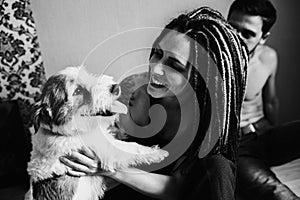 Young girl with dreadlocks holding a dog