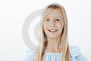 Young girl dreaming become actress, auditioning for advertisement. Studio portrait of happy dreamy little female child