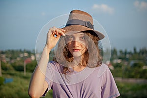 Young girl in dress is having great time during vacation in the summer on sky background in nature, travelling concept