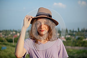 Young girl in dress is having great time during vacation in the summer on sky background in nature, travelling concept