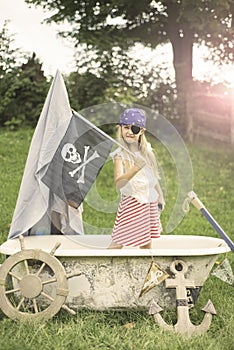 Young girl dressed as a pirate in a tub