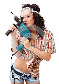 A young girl with drilling machine