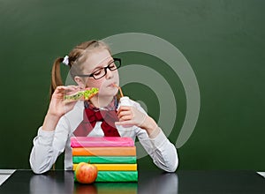 Young girl drink milk in classroom