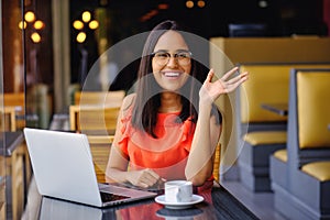 Latinamerican girl have a coffee break in a cafe photo