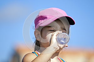 Young girl drinking water