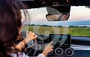 Young girl driving car using navigation system