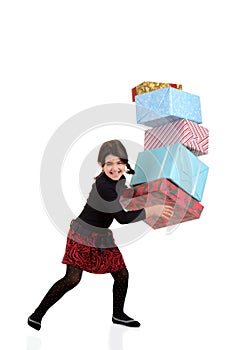 Young girl dropping pile of christmas gifts photo