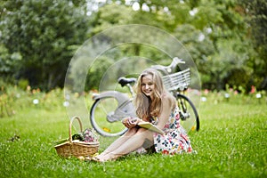 Young girl with eading a book outdoors