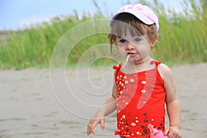 Young Girl eating on the beach