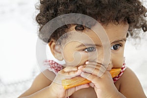 Young Girl Eating Carrot Stick