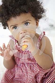 Young Girl Eating Carrot Stick