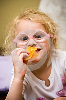 Young girl eating chips making funny face