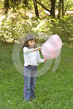 Young girl eating cotton candy