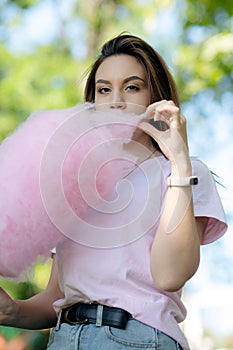 Young girl eating cotton candy