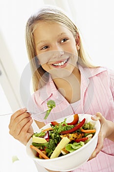 Young Girl Eating Fresh Salad