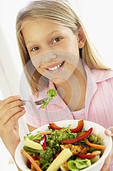 Young Girl Eating Fresh Salad