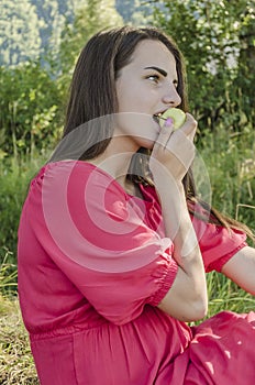Young girl eating a green Apple
