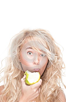 Young girl eating green apple on white background.