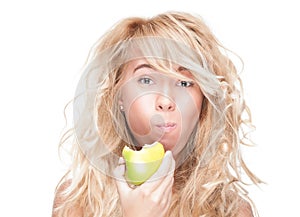 Young girl eating green apple on white background.