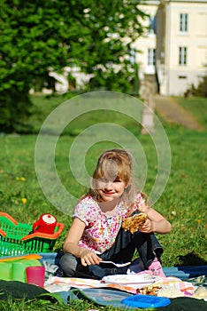 Young girl eating on picnic