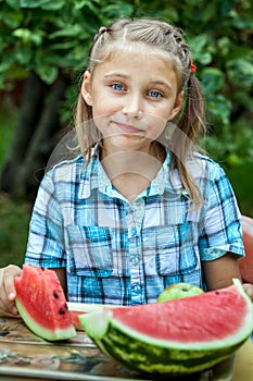 Young girl eating ripe watermelon