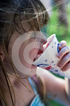 Young girl eating a snow cone