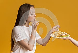 Young Girl Eating Taking French Fries From Plate With Fast Food