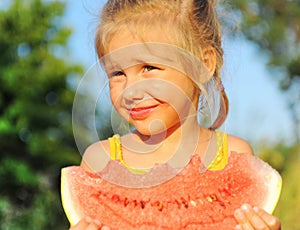 Young girl eating watermelon