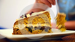 Young girl eats pumpkin cake in the cafe.