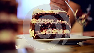 Young girl eats red velvet cake in the cafe.