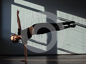 A young girl is engaged in jazz modern dance in the hall.