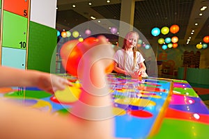 Young Girl Engaging in Colorful Board Game Fun at a Vibrant Playroom