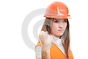 Young girl engineer holding her left fist up