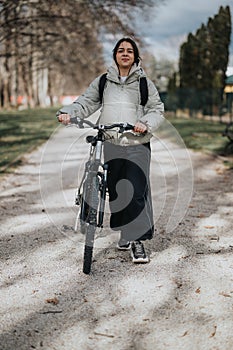 Young girl enjoying a carefree weekend cycling in the park