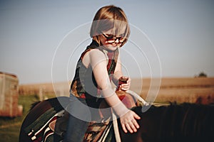 Young girl is enjoying a horse riding