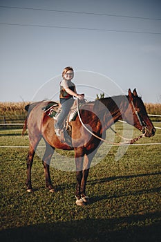 Young girl is enjoying a horse riding