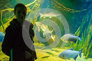 Young girl enjoying the marine life in aquarium tank Istanbul Turkey