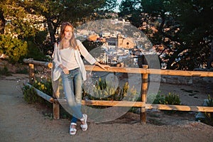 Young girl enjoying the sunrise at the Tossa de Mar, Catalonia