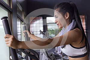 Young girl exercise bike cardio workout at fitness gym photo