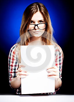Young girl with exercise book looking through the nerd glasses
