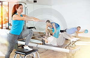 Young girl exercising on wunda chair in pilates studio