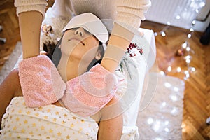 Young girl with eye mask relaxing at SPA