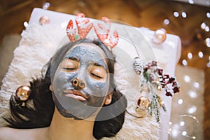 Young girl with face mask and Christmas headband